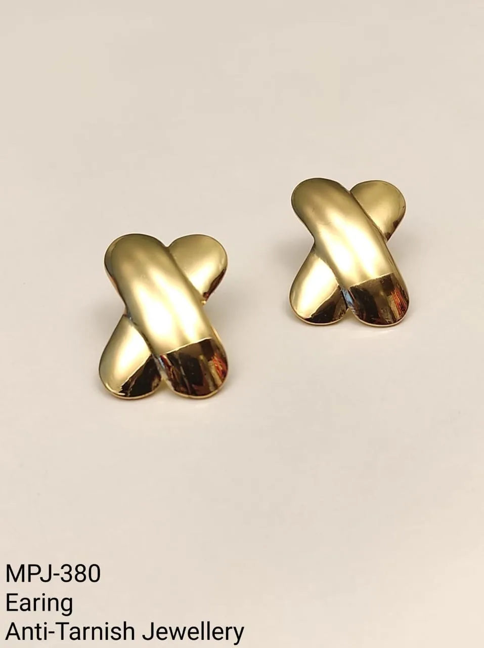 Gold-tone crossed design earrings — Gold